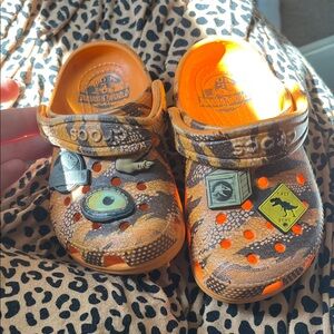CROCS Kids Orange and Brown Jurassic World Clog Shoes with Charms